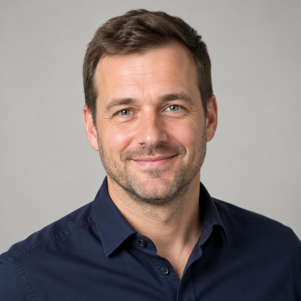 Portrait of a man with short hair and a friendly smile