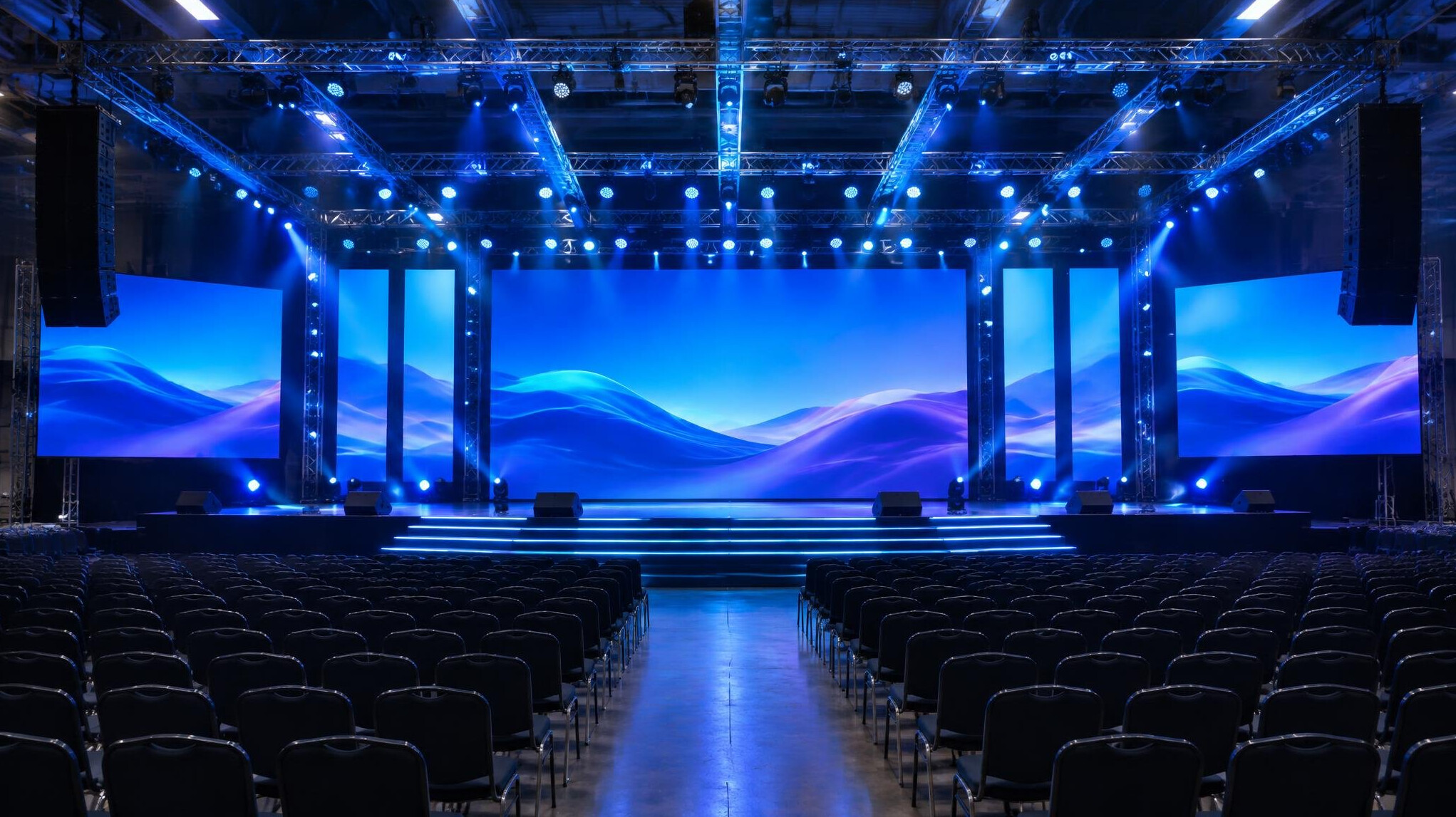 Large event stage with lighting and screens